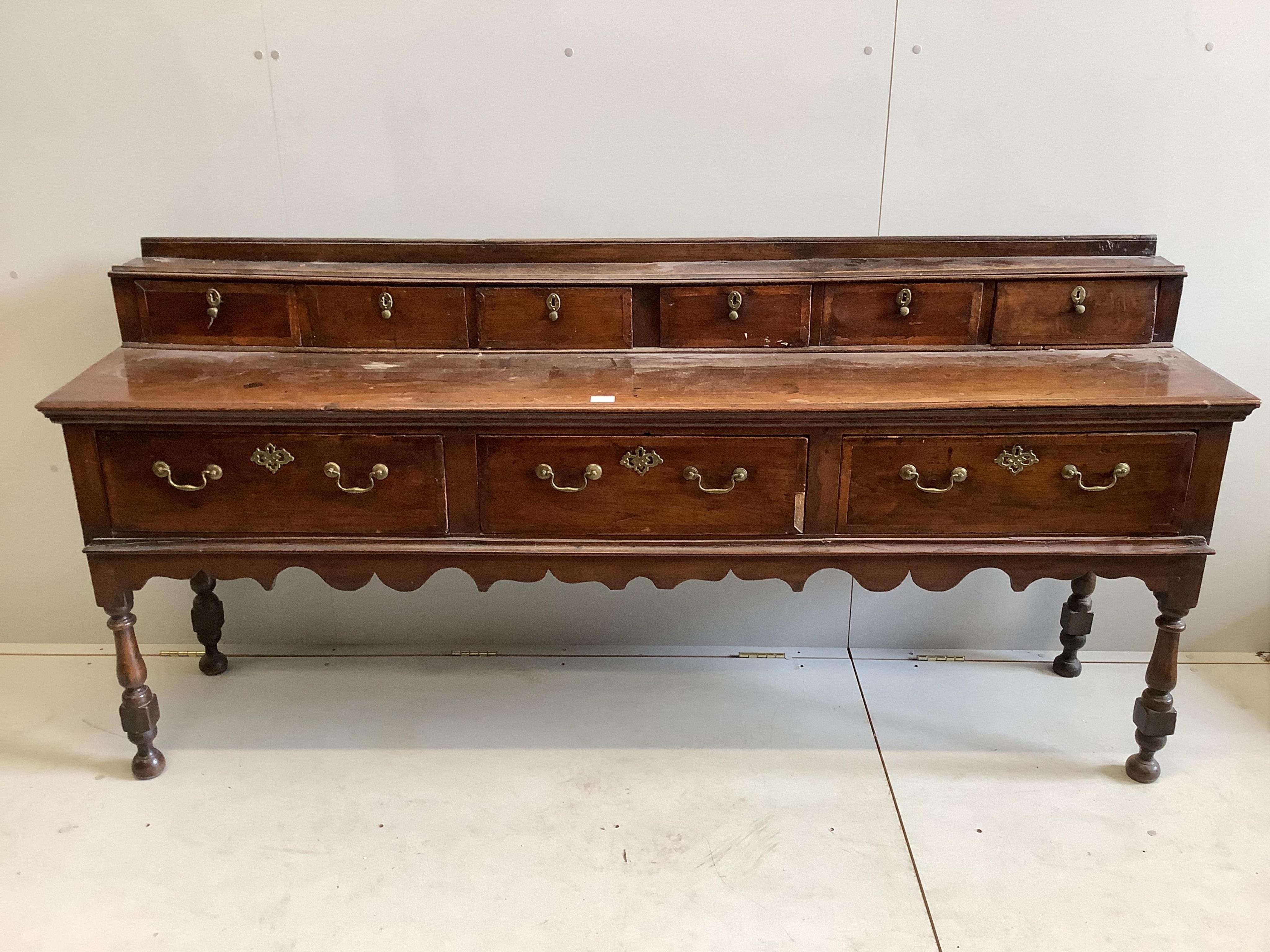 A mid 18th century oak low dresser, width 207cm, depth 46cm, height 97cm. Condition - fair